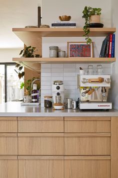 the kitchen counter is clean and ready to be used as a coffee bar or breakfast bar