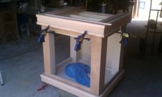 a wooden table with blue tarp on it in a room that is being worked on