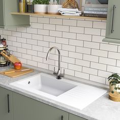 a kitchen sink with a cutting board on the counter