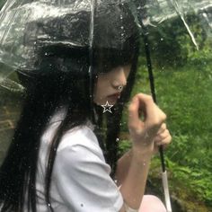 a woman holding an umbrella in the rain