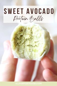 a hand holding a piece of creamy avocado protein balls with the words creamy avocado protein balls above it