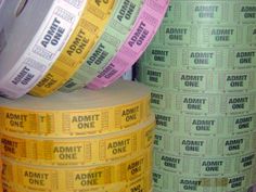 several rolls of admit tickets stacked on top of each other with the words admit one printed on them