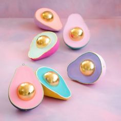 four pieces of art that look like egg shells with gold and pink decorations on them