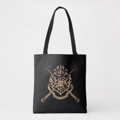 a harry potter tote bag with two crossed swords and hogwart's crest