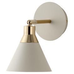 a white and gold wall light with a round shade on the side, against a white background