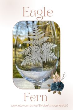 an image of a wine glass with a fern in the middle and words eagle on it