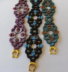 several different colored bracelets with gold clasps