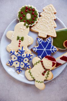 a white plate topped with lots of decorated cookies