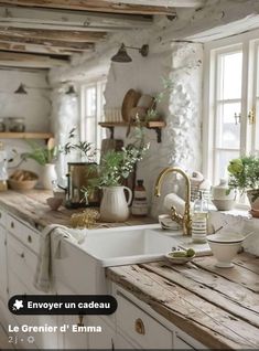 a kitchen filled with lots of white appliances and wooden counter top next to a window