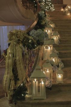 candles are lined up on the stairs with ribbons