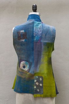 a mannequin wearing a blue and green vest