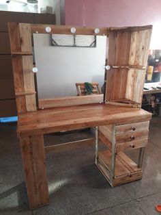 a wooden desk with drawers and a mirror