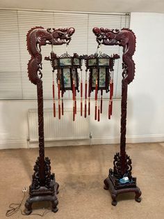 two ornate wooden stands with pictures hanging from them