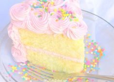 a piece of cake with pink frosting and sprinkles