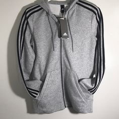 Brand New Adidas Essentials Cotton Fleece 3- Stripe Full Zip Hoodie Heather Grey/ Black Stripes Basic 3 Stripe Timeless Adidas Style All Around Comfort Zip Up Closure Retro Look Adidas Sportswear Hoodie With Three Stripes, Adidas Hoodie With Three Stripes For Sports Season, Winter Sports Sweatshirt With Three Stripes, Winter Adidas Activewear With Three Stripes, Adidas-style Winter Sportswear Activewear, Winter Athleisure Activewear With Three Stripes, Sporty Striped Hoodie With Drawstring, Striped Sporty Hoodie With Drawstring, Sporty Striped Sweatshirt For Winter