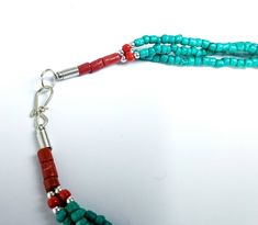 Add color and pizzazz to any outfit with this beautiful hand crafted Tibetan turquoise color multi strand bead necklace with silver tone amulets. The red faux coral makes the amulets pop! A simple but very striking necklace! Can be worn day or night. Makes a beautiful gift! Twist the necklace for a totally different look! Excellent quality and craftsmanship. - 3 strands of irregular beads - bright turquoise/teal color - silvertone amulets - secure hook closure Shop more necklaces: https://www.et Spiritual Turquoise Beaded Necklaces For Festivals, Handmade Turquoise Beaded Necklace For Festivals, Turquoise Beaded Necklaces For Festivals And Gifts, Turquoise Beaded Necklace For Festivals And Gifts, Blue Turquoise Necklace For Festivals Gift, Blue Turquoise Necklace For Festivals And Gifts, Turquoise Blue Necklace For Festivals And Gifts, Handmade Spiritual Multi-strand Turquoise Necklace, Turquoise Beads For Gifts And Festivals