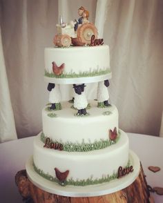 a three tiered cake decorated with farm animals