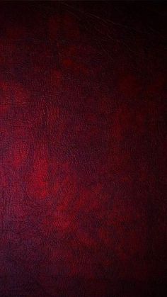 a red leather texture background or wallpaper that looks like it has been painted in different colors