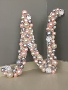 the letter n is made out of pearls