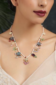 This necklace is a dainty, delightful piece. With a collection of quirky little unit, embellished with colorful stones and pearls, this necklace is perfect piece for the lovers of eccentric designs. Closure - Lobster Style Tip - Meet the perfect amalgam of poetic romance and the surrealism of fairy tales. Reminding us of clear starlit skies, magic and all the poems about love and passion, these designs are perfect for someone who wishes to add poetic details to their selections which are also re Whimsical Multicolor Wedding Jewelry, White Jeweled Kundan Necklace Gift, Bohemian Jeweled Kundan Necklace For Gift, Unique White Necklace For Festive Occasions, Unique White Necklaces For Festive Occasions, White Jeweled Necklaces For Celebration, Unique White Festive Necklaces, Party Multicolor Charms Necklaces, Multicolor Jeweled Beaded Necklaces As Gift