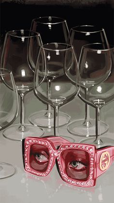 several wine glasses with sunglasses on them sitting next to each other