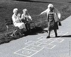 three elderly women playing hopo game in the park