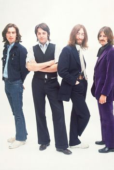 three men standing next to each other in front of a white background with their arms crossed