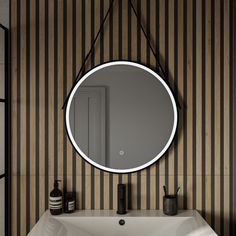 a bathroom sink with a round mirror hanging on the wall next to it's faucet