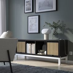 a living room with gray walls and white furniture