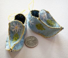 Adorable handcrafted elf shoes featuring and abundance of floral embroidery. These little felt shoes are lined with cotton calico. These sweet little shoes can be used as wall decor or hung off a dresser drawer as well as decoration on your Christmas tree. You could even hang them off the rear view mirror in your car. Whatever your heart desires. These sweet little shoes also fit on the standard dolls with an L shaped foot.  The shoes come with a string attached for easy hanging but can easily b Pixie Doll, Gig Harbor Wa, Elf Shoes, Unicorn Doll, Felt Shoes, Gig Harbor, Dresser Drawer, Mermaid Dolls, Glue Crafts