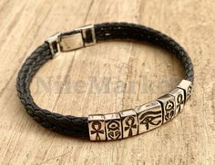 "Personalized ancient Egyptian Silver Themes Charms In Black Leather braided woven Bracelet .made from high grade quality sterling silver. Excellent for a male or female and looks simply stunning.Would make an excellent gift your lover. Please leave a note with your payment / purchase or( email us )with : 1-The charms (Center charm eye of horus) and side charms between (scarab charm or ankh charms )you like to have it total to be 6 side charms please let me know what you prefer and in which styl Symbolic Adjustable Rectangular Jewelry, Egyptian Bracelet, Bronze Bracelets, Silver Theme, Egyptian Jewelry, Woven Bracelet, Eye Of Horus, For Her Gifts, Mens Leather Bracelet