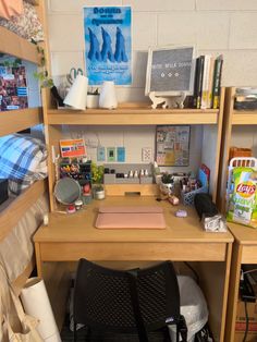 there is a desk and chair in the room with bookshelves on the wall