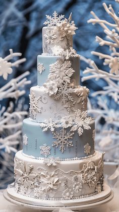 a three tiered cake with snowflakes on it