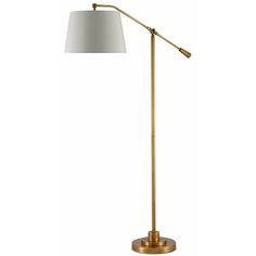 a gold floor lamp with a white shade on the base and a light bulb in the middle