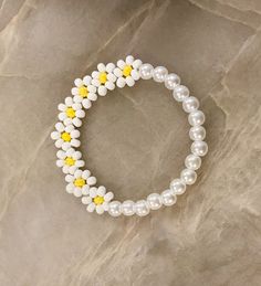 Pearl Flower Beaded Bracelet Half flowers and half pearls, what could be better! The cutest bracelet to add to your collection. 🐚🌼 Made with faux pearls and white & yellow seed beads. See other listings for other color options or message us.  This is bracelet is perfect for the bride or flower girl 💍 CARING TIPS FOR YOUR JEWELRY ⭐️Treat and store with care. ⭐️ For longevity, avoid exposing your jewelry to water. ⭐️ Avoid having direct contact with lotions, perfumes, sanitizers as these chemicals may cause discoloration of your jewelry. Seed Bead Flower Jewelry, Softball Beaded Bracelet, Adjustable White Bracelet With Flower Decoration, White Beaded Bracelets With Flower Charm For Spring, Spring White Beaded Bracelets With Flower Charm, White Beaded Pearl Bracelet With Flower Shape, White Beaded Pearl Bracelet With Flower Design, Handmade White Pearl Bracelet With Flower Shape, White Beaded Flower Pearl Bracelet