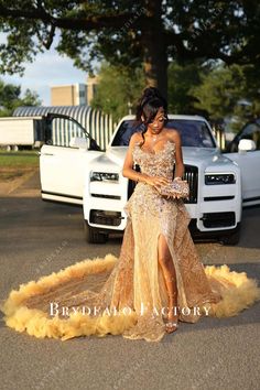 Make an entrance in a marigold strapless beaded prom dress with a thigh-high slit and ruched long train overskirt. A glamorous and bold choice for any special event. Brooklyn Frost Prom, Homecoming Dresses For Black Women, Prom Dress Inspiration Gold, Gold Prom Dress Inspiration, Gold Matric Dance Dresses, Long Prom Dress Ideas, Prom Dress Inspo Black Woman, Creme Prom Dress, Senior Prom Dress Ideas