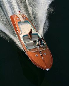 a man riding on the back of a wooden boat