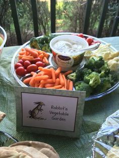 a table topped with lots of different types of vegetables next to bowls of dips