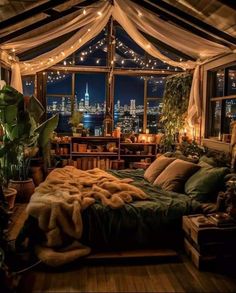 a bedroom with lights strung from the ceiling and curtains over the bed, windows to the city below