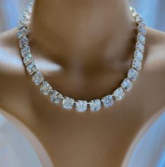 This is a beautiful Anna Wintour tennis necklace that looks like real Diamonds. These crystals are AAA vvs1 Asscher Cut 10 mm cubic zirconia. They sparkle and are intricately cut exactly like the gemstone. Absolutely Elegant. Matching earrings a lovely touch. https://www.etsy.com/shop/AmysFinery Dazzling Diamond White Crystal Tennis Necklace, Diamond White Crystal Tennis Necklace With Rhinestones, Crystal Tennis Necklace With Diamond Accents, Wedding Tennis Necklace In Diamond White With Rhinestones, Anniversary Crystal Tennis Necklace With Diamond Accents, White Round Cut Crystal Tennis Necklace, White Cubic Zirconia Diamond Necklace Iced Out, White Diamond Necklace With Iced Out Cubic Zirconia, Iced Out Cubic Zirconia Diamond White Necklace