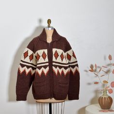 So in love with this perfect 1970s hand knit Cowichan sweater jacket. Gorgeous autumn pallet and minimalist graphic motif that wraps around. Heavy duty front zip and front pockets. Cozy heavy weight. Perfect for fall/winter. Good condition with normal wear to knit for age.  MEASUREMENTS: BUST: 46" WAIST: 46" HIP: 46" LENGTH: 28" Dark Academia Knitting, Retro Knitted Outerwear For Fall, Retro Wool Sweater With Fair Isle Pattern, Vintage Wool Cardigan With Fair Isle Pattern, Vintage Fair Isle Pattern Outerwear For Fall, Retro Fair Isle Pattern Outerwear For Fall, Vintage Fair Isle Outerwear For Fall, Retro Fair Isle Outerwear For Fall, Vintage Winter Jacquard Knit Cardigan