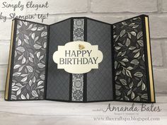 an open card with the words happy birthday written in white and black, on it