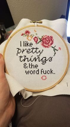 someone is holding up a cross - stitch sample with the words, i like pretty things and the word luck