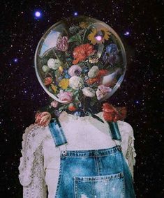 a person with overalls and flowers in their hair is standing under a glass ball