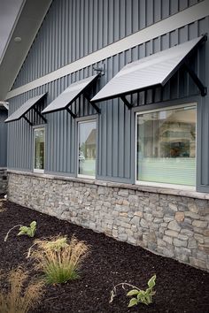 an outside view of a building with windows and plants