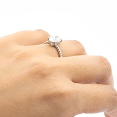 a woman's hand with a diamond ring on it