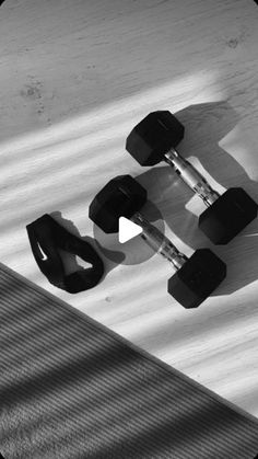 black and white photo of skateboard with wheels on it's back end, viewed from above