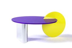 a purple and yellow table sitting on top of a white floor