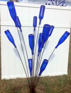 a bunch of blue glass sticks sticking out of the ground