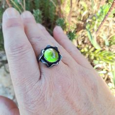 Fused Glass Ring. Flower Ring. Sterling Silver And Fused Glass Ring. Lime Ring. Lime Glass Ring. Artisan Ring. Original Ring.  It's a really pretty ring. An aged, lightly polished silver flower with a gorgeous lime green crystal. It is a glass handcrafted by me in a high temperature oven. It's unique. Depending on the light that hits it, the reflections are really beautiful. It is a ring full of life. You'll love it. *MEASURES: Crystal Size 1 x 1 cm (0.39 x 0.39 inches) in diameter. The ring is adjustable, if you know your measurement, tell me and I will send it to you pre-adjusted (in the photo gallery you have the ring measurements for different countries), if you don't know it, you can adjust it yourself. * PACKAGING Your jewelry is shipped in a kraft gift box. If you want, you can pers Handmade Green Opal Promise Ring, Unique Green Opal Promise Ring, Green Handmade Fusion Rings, Artisan Hand Forged Green Rings, Artistic Hand Painted Round Rings, Handmade Green Opal Round Ring, Handmade Green Opal Ring, Unique Green Flower Ring, Handmade Green Flower Ring